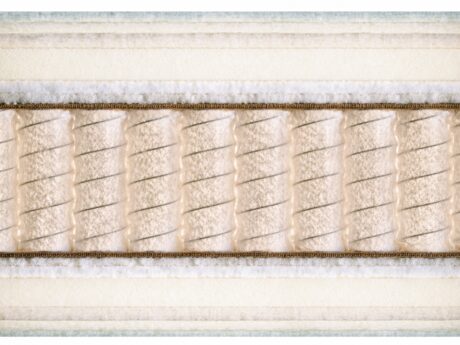 Close-up cross-section of Schramm Emotion Luxe handmade mattress showing natural material layers including cotton wadding, jute border, and individual barrel-shaped pocket springs, handmade in Germany