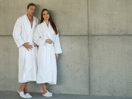 Man and a woman wearing a white Abyss & Habidecor bathrobe