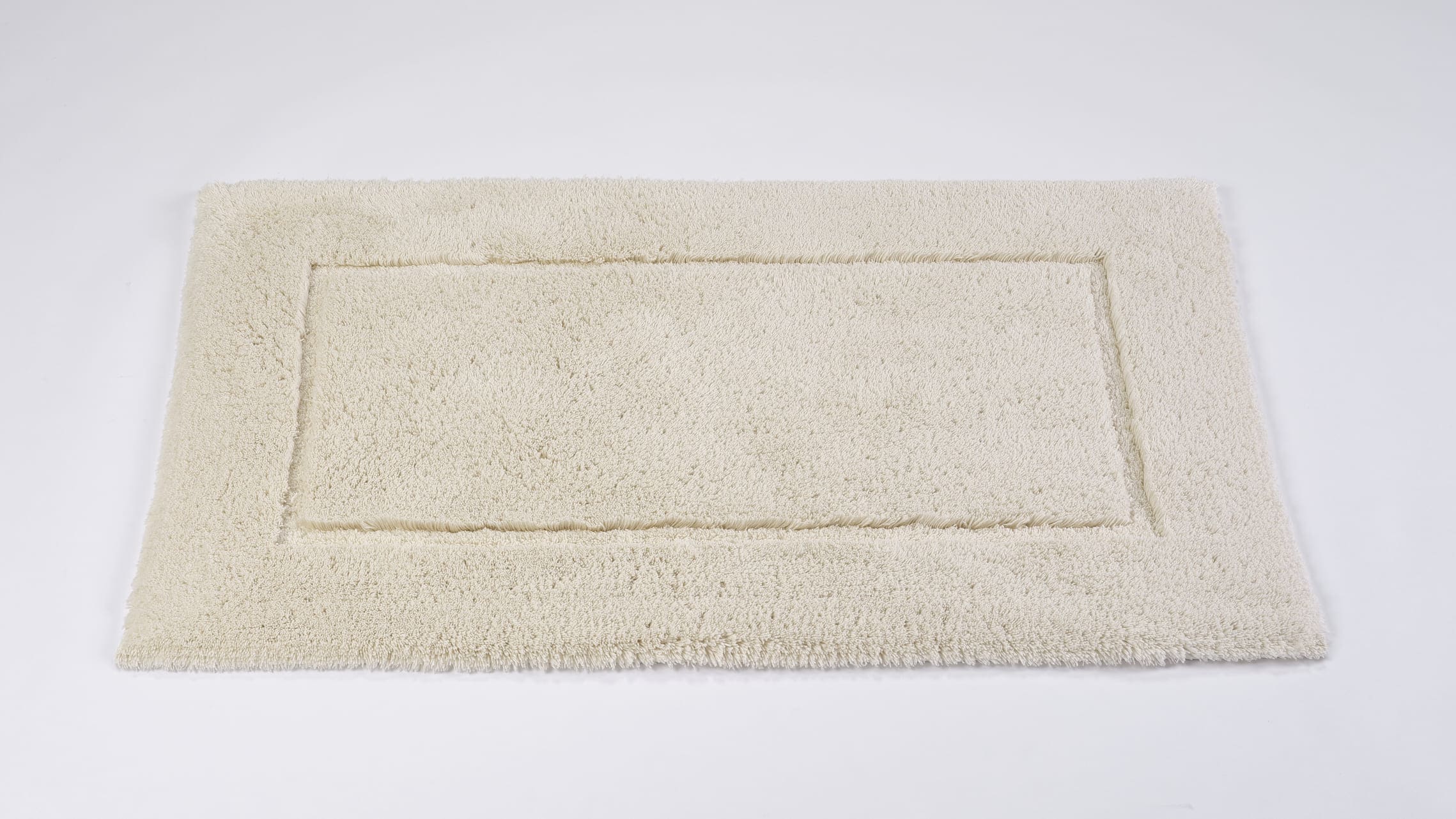 Abyss & Habidecor Must ivory bath mat with border