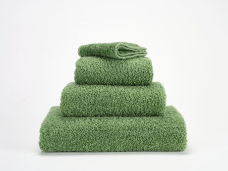 Abyss & Habidecor Super Pile luxury cotton towel set in fresh green stacked on white background