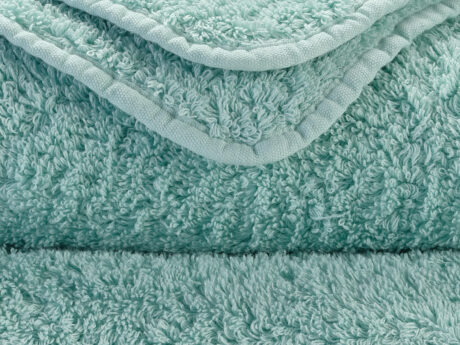 Close-up of Abyss & Habidecor Super Pile aqua green cotton towel showing plush texture and premium edging
