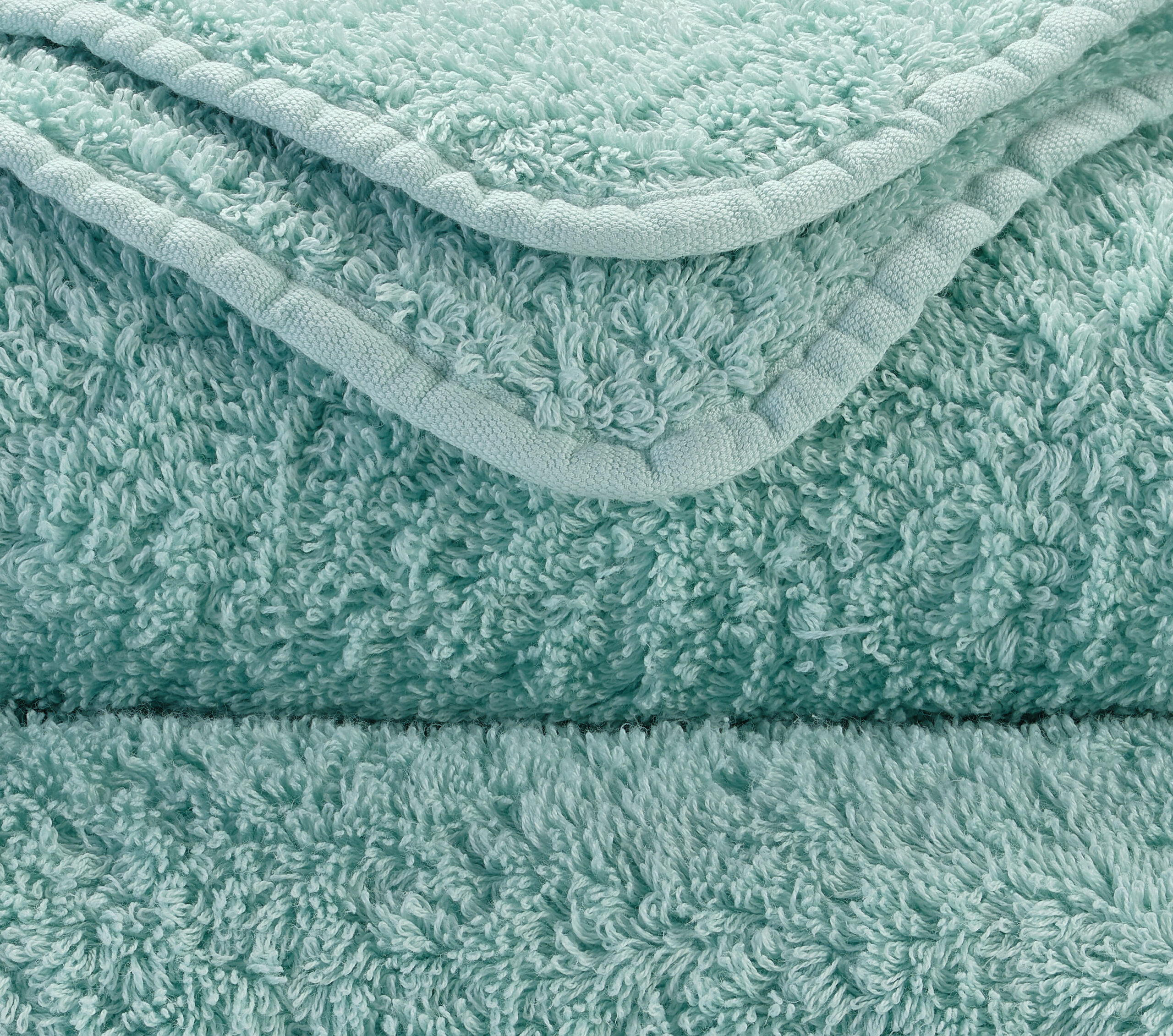 Close-up of Abyss & Habidecor Super Pile aqua green cotton towel showing plush texture and premium edging