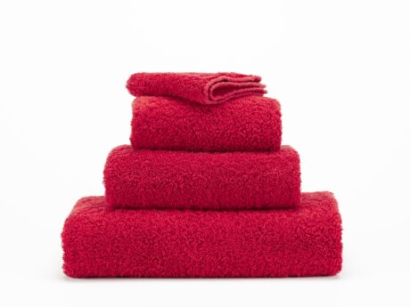 Abyss & Habidecor Super Pile 564 luxury cotton towels in red stacked