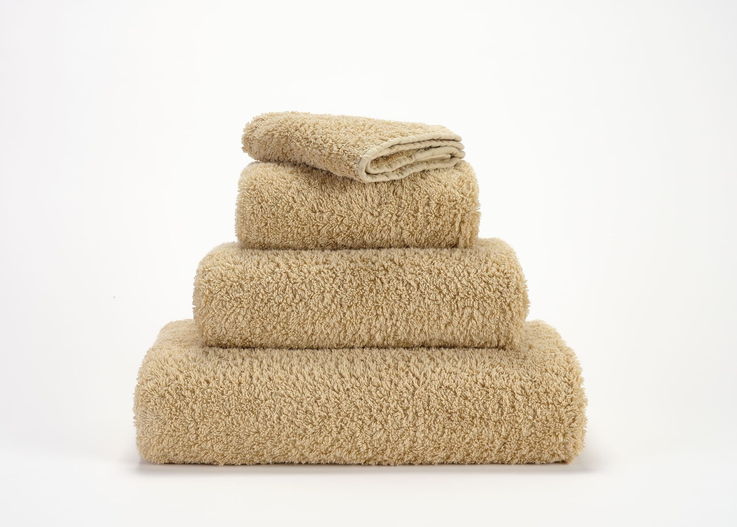 Abyss & Habidecor Super Pile 714 luxury cotton towels in beige stacked