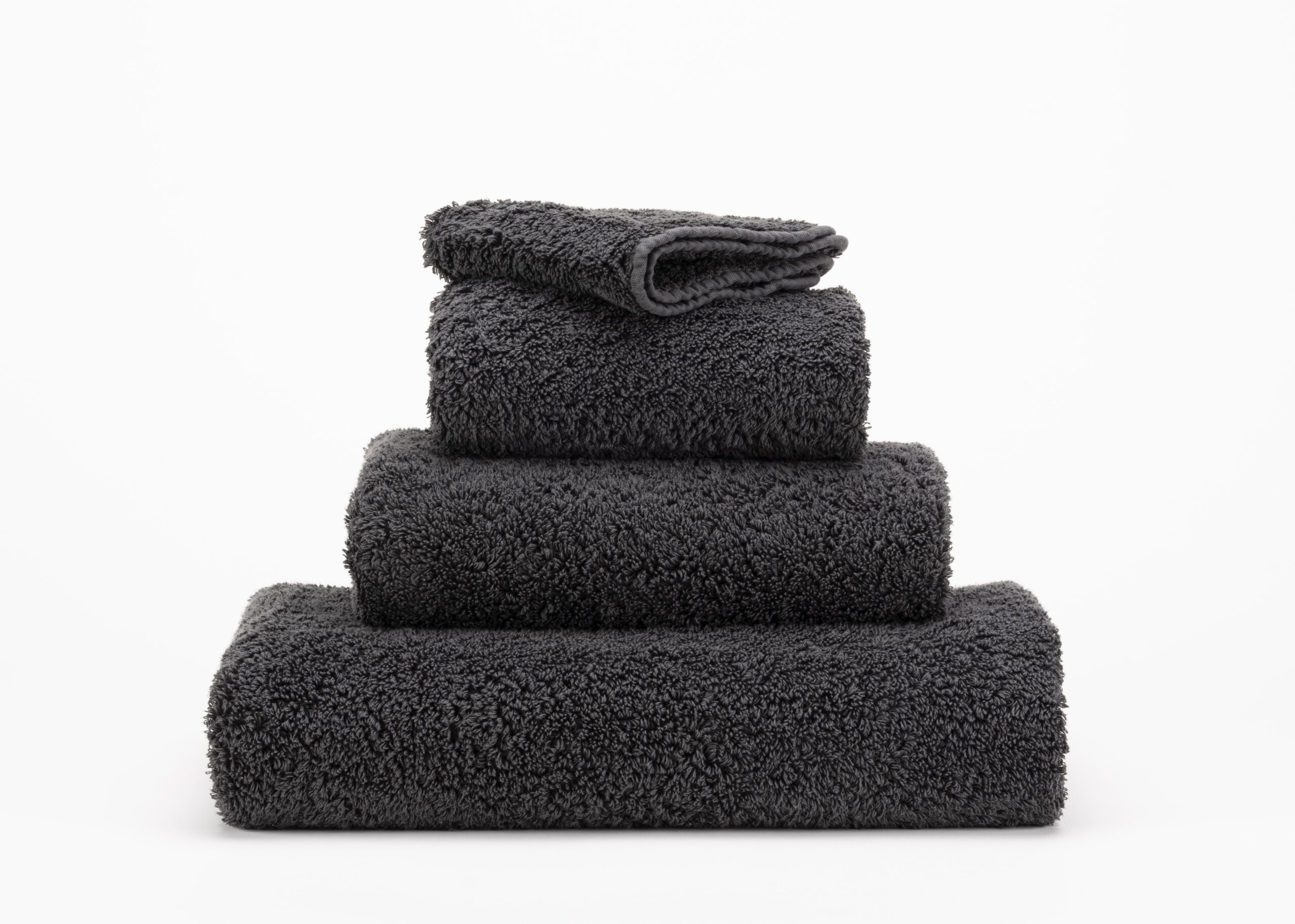 Abyss & Habidecor Super Pile 997 luxury cotton towels in dark charcoal stacked