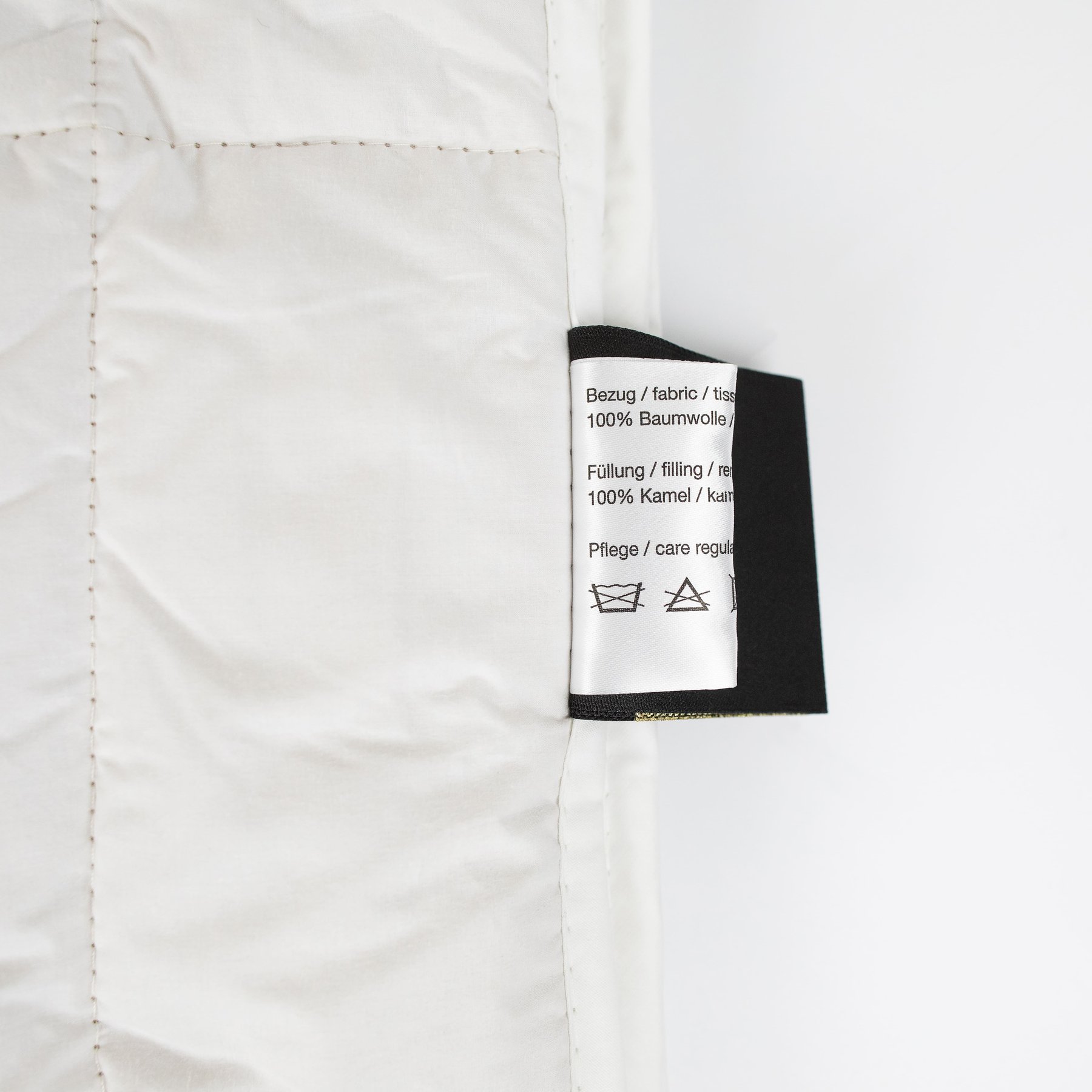 Care label of Traumina Luxury N°1 duvet showing fabric and filling details