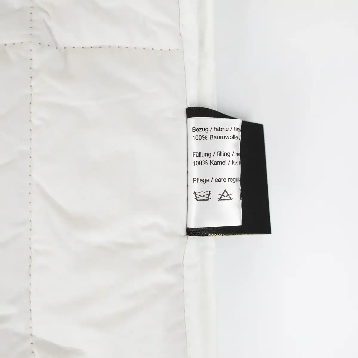 Care label of Traumina Luxury N°1 duvet showing fabric and filling details