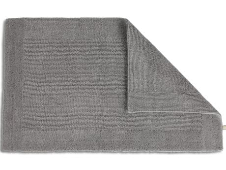 Rhomtuft Prestige cotton bath mat in pebble, corner folded to show the reverse side