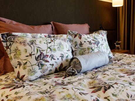 Von der Thannen Clay Peony satin bed linen on a double bed