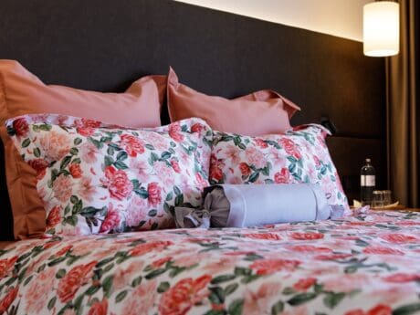 Von der Thannen Coral Peony satin bed linen on a double bed