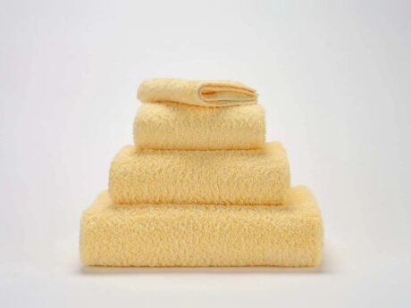 Abyss & Habidecor Super Pile 803 luxury cotton towels in soft yellow stacked