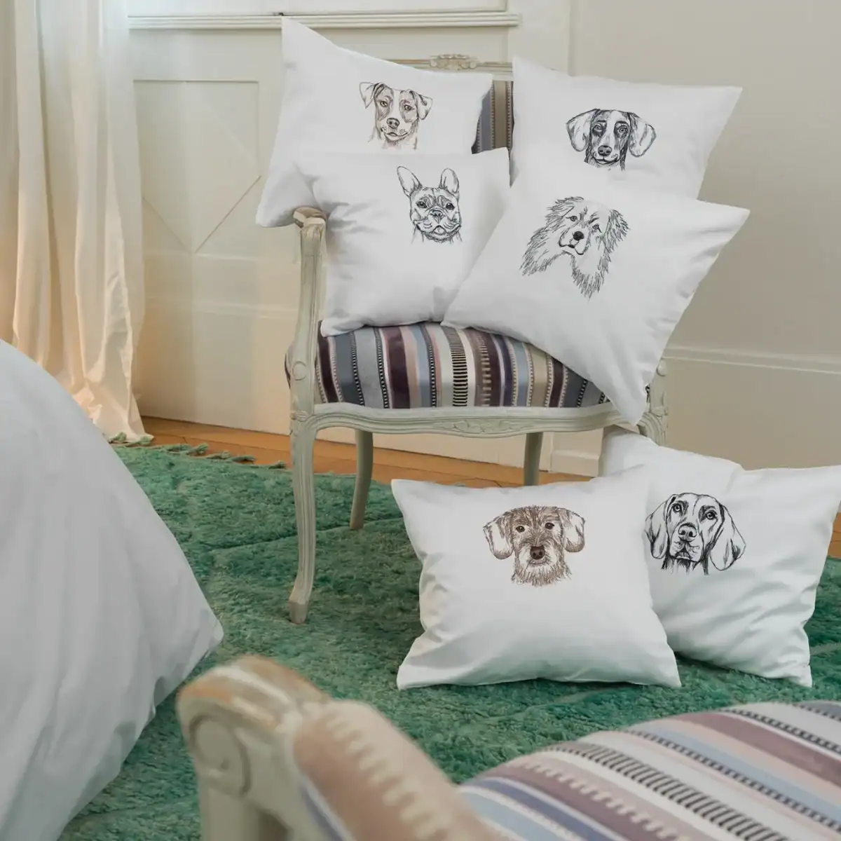 Graser dog embroidery collection on a bed